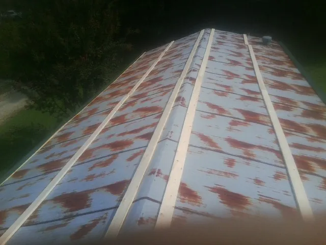Rusted metal roof panels with new wood purlins before replacement — Storm Damage Roof Repair in Marina Del Rey by Roofing Brothers